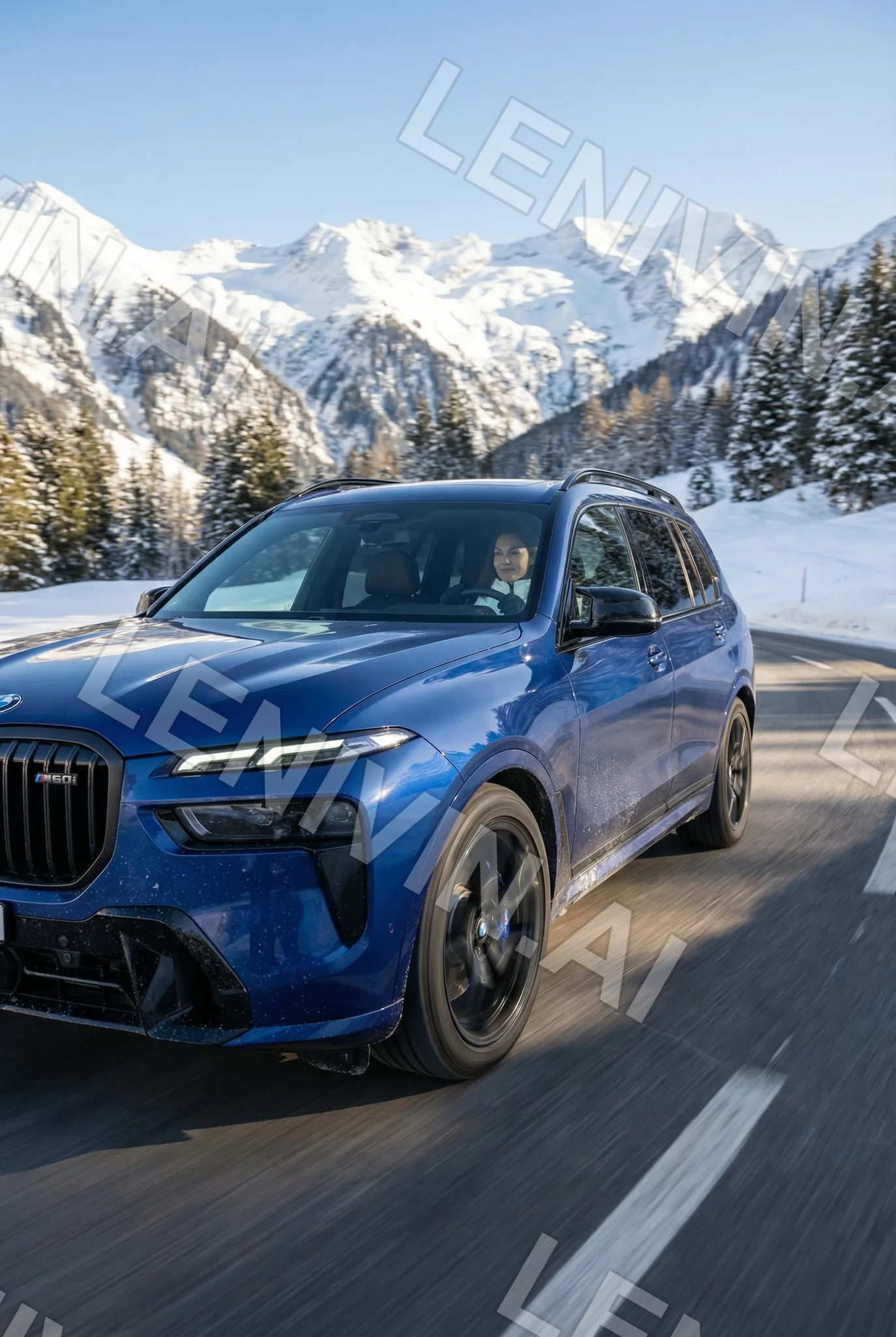 синий BMW внедорожник едет по заснеженной горной дороге, вдали снежные вершины